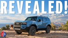 a blue truck parked on top of a dirt hill with the words revealed above it