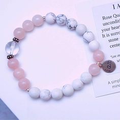 Our "I Am" Bracelet Collection features bracelets that are a simple and powerful reminder to remain mindful and intentional each day in your life. I Am Love: Rose Quartz is the stone of unconditional love, opening your heart to all forms of love. It is surrounded by Howlite the stone of patience, and one center Quartz crystal ball. Affirmation: "Love and compassion are necessities, not luxuries. Without them humanity cannot survive". - Dalai Lama Features: Made with 26 gemstones in Rose Quartz, Everyday Inspirational Pink Bracelets, Minimalist Bracelets With 8mm Beads For Healing, Adjustable Healing Bracelets With Meaningful Style, Everyday Beaded Rose Quartz Bracelets, Inspirational Pink Round Beads Jewelry, Spiritual Everyday Rose Quartz Beaded Bracelets, Pink Natural Stones Bracelet For Friendship, Pink Natural Stone Bracelets For Friendship, Adjustable Rose Gold Bracelet For Meditation