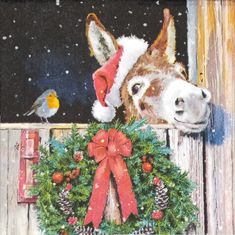 a donkey wearing a santa hat standing next to a christmas wreath with a bird on it