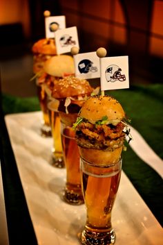 three tall glasses filled with food sitting on top of a table