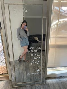 a woman taking a selfie in a mirror