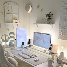 a white desk topped with two computer monitors and a keyboard sitting on top of it