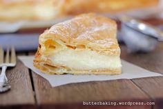 a pastry sitting on top of a piece of paper next to a fork