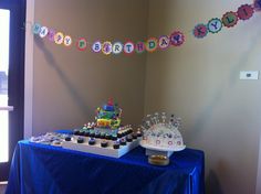 a birthday cake and cupcakes on a table