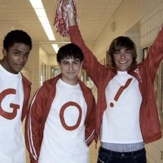 three young men wearing red and white shirts with the word go on them