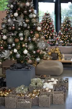 the christmas tree is decorated with silver and gold ornaments