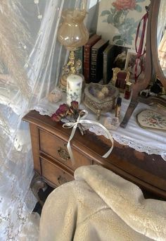 an old dresser with a mirror, candles and other items on it