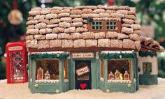 a gingerbread house is decorated with icing and christmas decorations for the holiday season