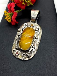 Artisan Baltic Amber Pendant  Hand-made Sterling Silver 925  Stones used: Baltic Amber, Garnet, Citrine  Height - 2 7/8” (including bail), Width – 1 1/4”  Height – 72mm (including bail), Width – 32mmUnique Handcrafted One-of a-kind Design PendantEach Piece of Jewelry in my Collection is Absolutely One of a Kind!When you start wearing a piece of my jewelry you will fall in love with it more and more each day and feel that good Energy and Love that I pass into it while creating this piece of Art.A Artisan Pendant Jewelry With Polished Finish, Unique Amber Jewelry Stamped 925, Artisan Silver Citrine Jewelry, Handmade Sterling Silver Gemstones For Collectors, Amber Pendant Jewelry Stamped 925, Handmade Citrine Pendant Jewelry, Artisan Handmade Gemstones For Anniversary, Handmade Artisan Gemstones For Anniversary, Citrine Jewelry Stamped 925