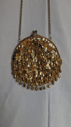 This beaded handbag is in great shape, lots of fine details and has a great sparkle when the light hits it.  Chain/strap is gold and 20 inches.  Made in Macau Gold Sequined Bags For Party, Gold Sequined Party Bag, Gold Sequin Party Bag, Gold Party Bags With Sequins, Gold Sequined Evening Bag For Parties, Gold Sequined Clutch For Party, Gold Sequin Clutch For Parties, Elegant Gold Bags With Sequins, Gold Sequined Shoulder Bag For Evening