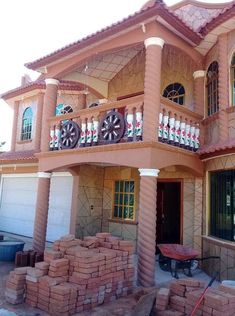 a pink house with lots of windows and balconies