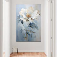 a white flower on a blue background in an empty room