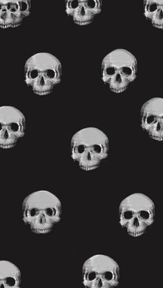 a black and white photo of skulls with different facial expressions on it's face