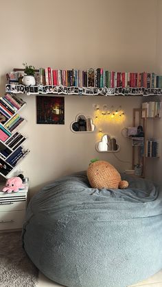 there is a bean bag chair in the corner with books on the shelves above it