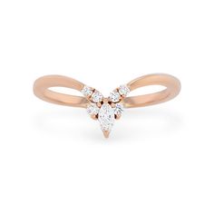 a rose gold ring with three pear shaped diamonds