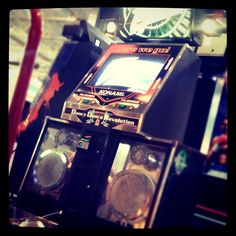 an old fashioned video game machine sitting on top of a table next to other electronic devices