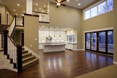 a large open floor plan with stairs leading up to the kitchen and living room area