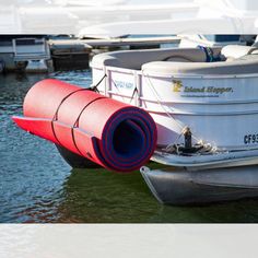 there is a red tube attached to the back of a boat