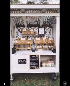 an outdoor food cart with lots of items on it