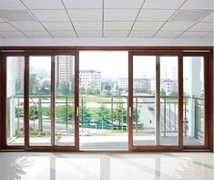 an empty room with sliding glass doors leading to a large open area in front of the window