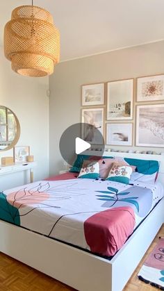 a bed room with a neatly made bed and pictures hanging on the wall above it