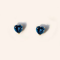 Forever classic, heart-shaped natural London blue topaz stud earrings handcrafted in 9K solid gold. Made to Order. Ship within 3-4 weeks. - Stone info: 5mm heart cut natural London blue topaz - Stone weight: 1.2ctw - Sold as A Pair. - The earrings come with 10K gold silicone backings. - Made in 9 karat gold. - Stamp with 9K. Cheap Handmade Blue Heart Earrings, Lexy Cross, Blue Heart Ring, Pokemon Jewelry, Blue Stud Earrings, Gold Topaz, Silver Jewelry Design, Blue Topaz Stone, Dainty Studs