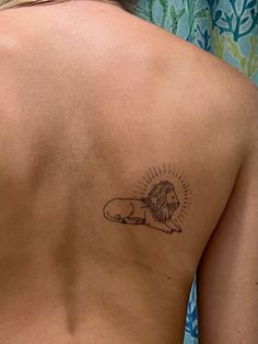 a woman with a lion tattoo on her back