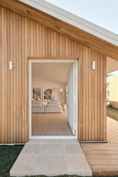 an open door leading into a room with wooden walls and flooring on the outside