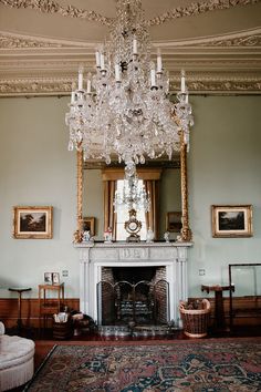 a chandelier hanging from the ceiling in a room with blue walls and carpet