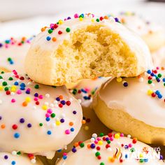 a plate full of italian wedding cookies with white frosting and sprinkles