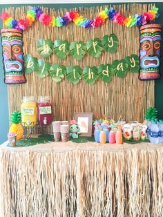 a tiki themed birthday party with food and decorations