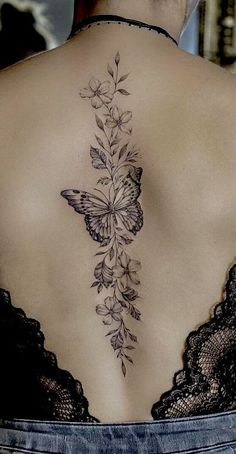 a woman with a butterfly tattoo on her back