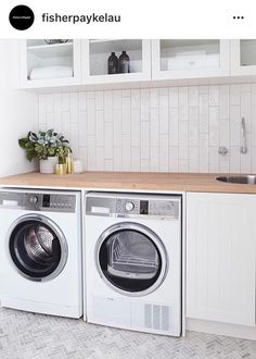 there is a washer and dryer in the kitchen next to eachother