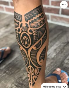 a man's leg with an intricate tattoo design on the calf and lower leg