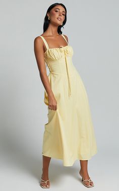 Make a bold statement in the Debby Midi Dress. This stunning yellow A-line dress exudes summer vibes with its vibrant lemon hue. Made from a blend of cotton and rayon, this sleeveless maxi dress is both comfortable and lightweight, perfect for those hot party nights. The bust tie front adds an extra touch of femininity and allows you to adjust the fit to your liking. Whether you're hitting the dance floor or sipping cocktails by the beach, this Debby Maxi Dress will make sure all eyes are on you Spring Sundress Maxi Dress In Cotton, Spring Cotton Sundress Maxi Dress, Sleeveless Cotton Maxi Dress For Summer, Cotton Sundress Maxi Dress For Spring, Cotton Maxi Dress For Summer Garden Party, Cotton Maxi Dress For Summer Brunch, Yellow Midi Dress For Summer, Summer Cotton A-line Midi Dress, Yellow Midi Sundress For Summer