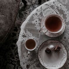 two cups of tea sit on a table