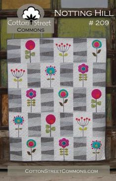 a quilt with flowers on it and the words cotton street commonss next to it