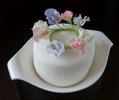 there is a white cake with flowers on it