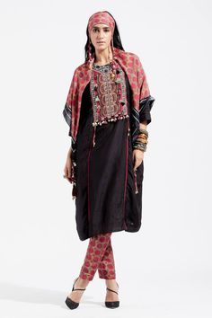 Black kurta with embroidered yoke, featuring resham thread embroidery with sequins, cowry shells and tassel embellishments and contrast seam inserts. Paired with printed narrow trouser.
Component: 2
Embroidered, Printed
Neckline: Round
Sleeve Length: Three Quarter
Fabric: Kurta: Cotton Silk; Trouser: Cotton 
Color: Black, Red
Side gathering panel
Back keyhole closure
Back elasticated trouser
Note: The stole and top worn by the model is for styling purpose only - Aza Fashions Linen Kurtas, Embroidery With Sequins, Black Kurta, Kurta Cotton, Black Lehenga, Embroidered Handbag, Fitted Tunic, Designer Salwar, Designer Salwar Suits