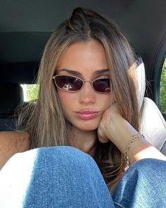 a woman sitting in the back seat of a car