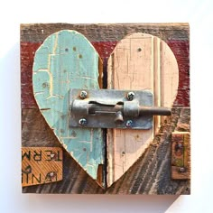 a heart shaped door with a lock on it's side and two pieces of wood in the middle