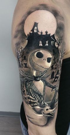 a man with a tattoo on his arm that has a skeleton and castle in the background