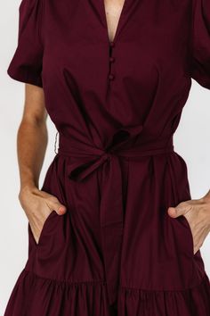 A simple and easy-to-wear dress with cute details Deep wine color that pulls purple Cotton material has no stretch Fit runs big, we recommend sizing down if wanting a more fitted look V-neckline with ruffled collar Three functional loop buttons on front bodice Removable self-tie waist sash Functional side pockets Tiered skirt Unlined 100% Cotton Trina is 5'6, cup size 32D, size 2 and is wearing size XS Baltic Born, Waist Sash, Ruffled Collar, Poplin Dress, Wine Color, Wine Colored, Tier Skirt, Look Your Best, Cup Size