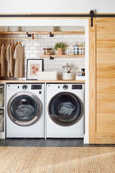 a washer and dryer sitting in front of a closet with open shelving