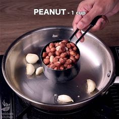 a person stirring beans in a pan on top of a stove with the words peanut - 1 cup above it