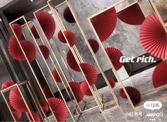 an advertisement with red paper fans hanging from the ceiling in front of a marble wall