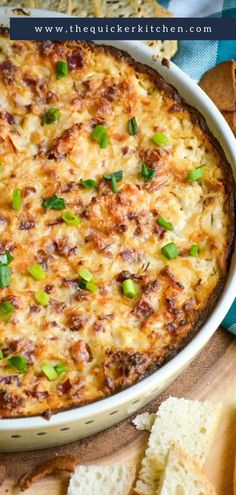 a casserole with cheese and green onions in a white dish next to crackers