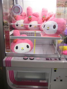 some pink stuffed animals in a display case