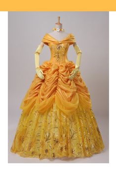 a yellow dress with gold sequins on it