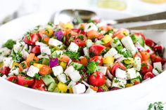 a white bowl filled with lots of colorful vegetables